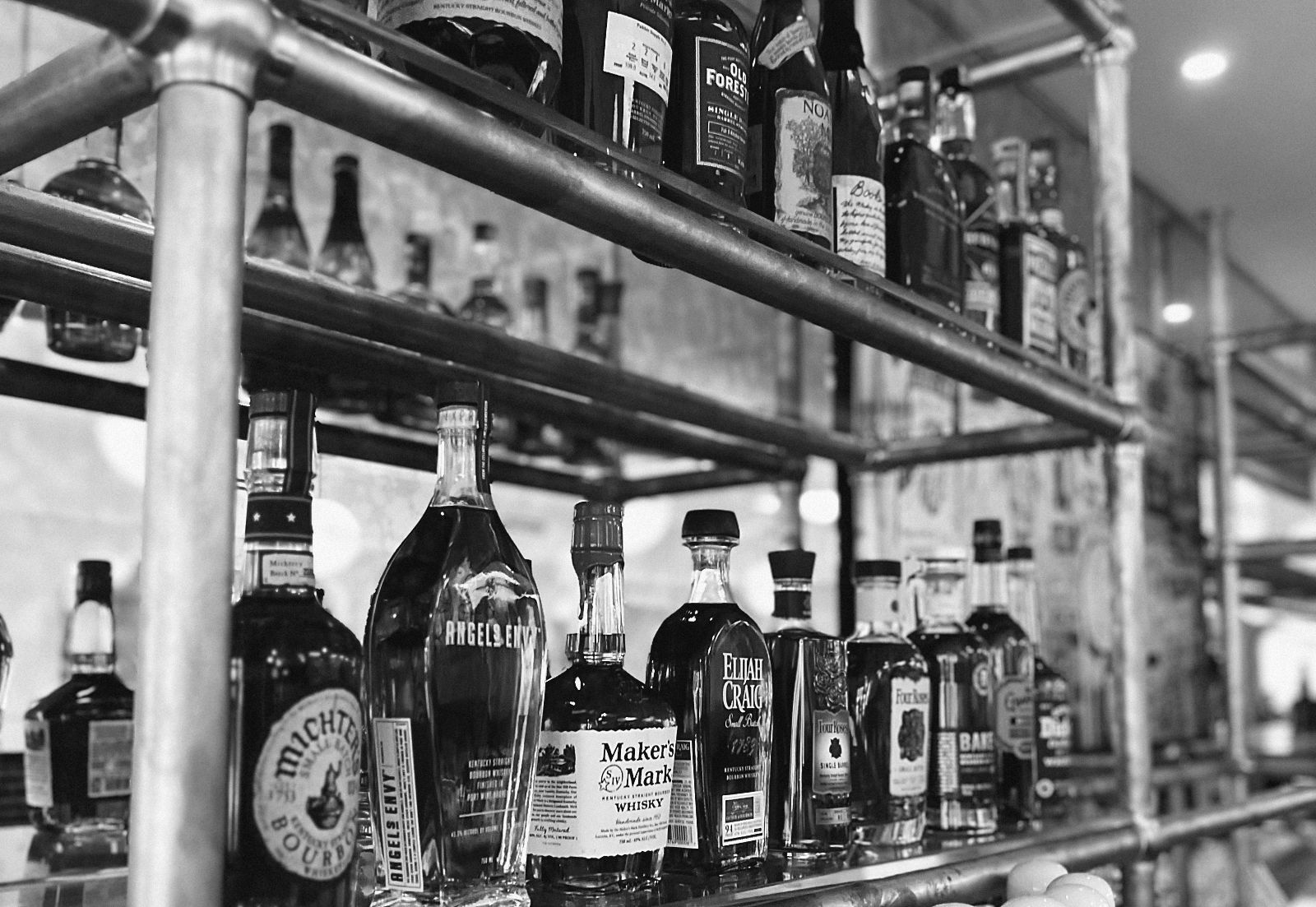 A back bar of brass shelving lined with bottles