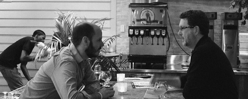 Dave talking with a guest across the bar