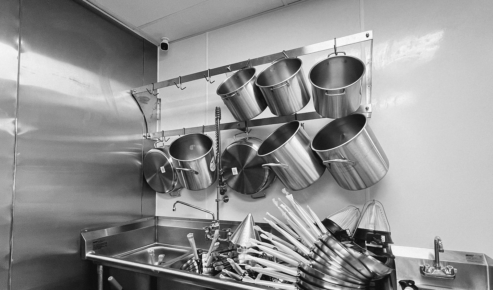 A pot rack over a prep sink