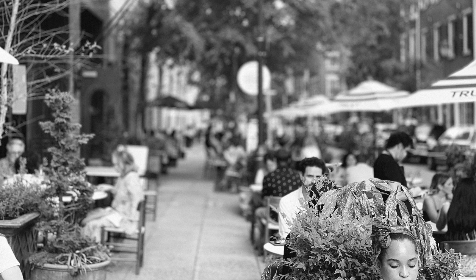 A full sidewalk dining street